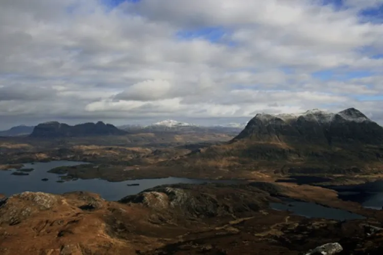 View across lochs and moorland to the Assynt mountains